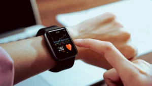 A woman checks a health tracker on her wrist